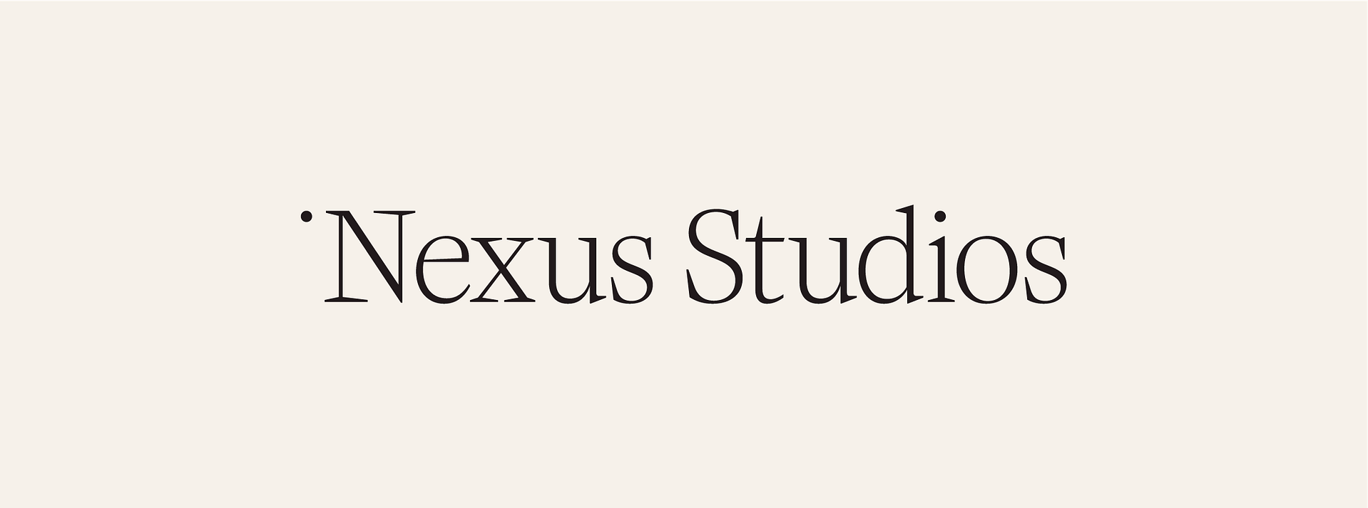 The image displays the logo of "Nexus Studios" set against a plain beige background. The logo is written in an elegant, serif font, with the word "Nexus" featured prominently on the left, and "Studios" aligned to the right, both in the same line. The typeface is sophisticated with thin and elongated characters, emphasizing a sleek and modern aesthetic.