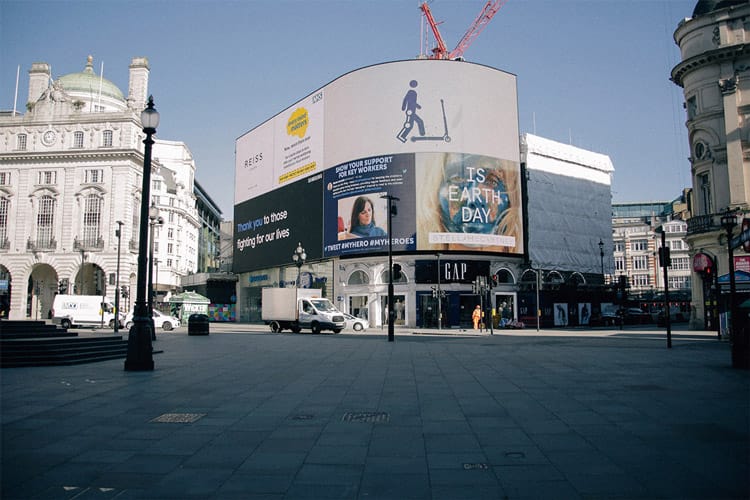 A shot of Piccadilly Circus focusing on the big wall of digital advertising screens.